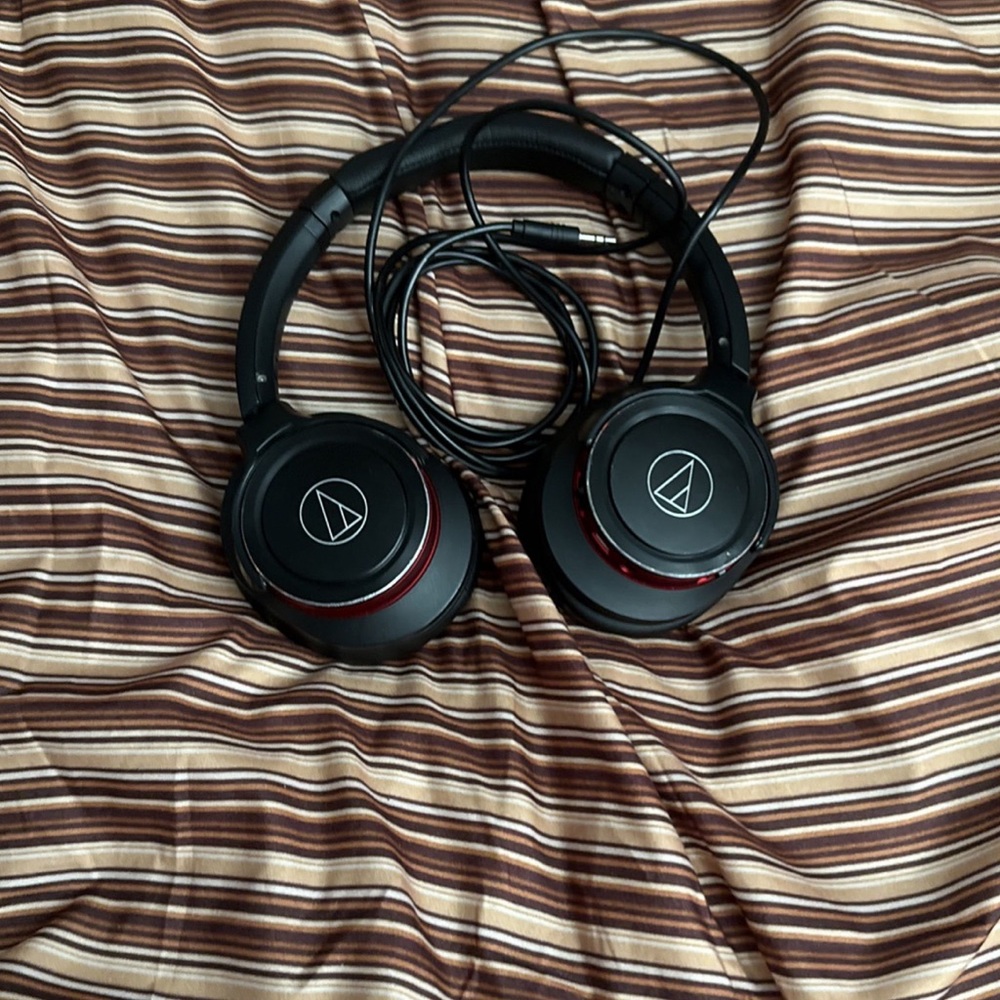 Black headphones could be Bluetooth or wired and is loud